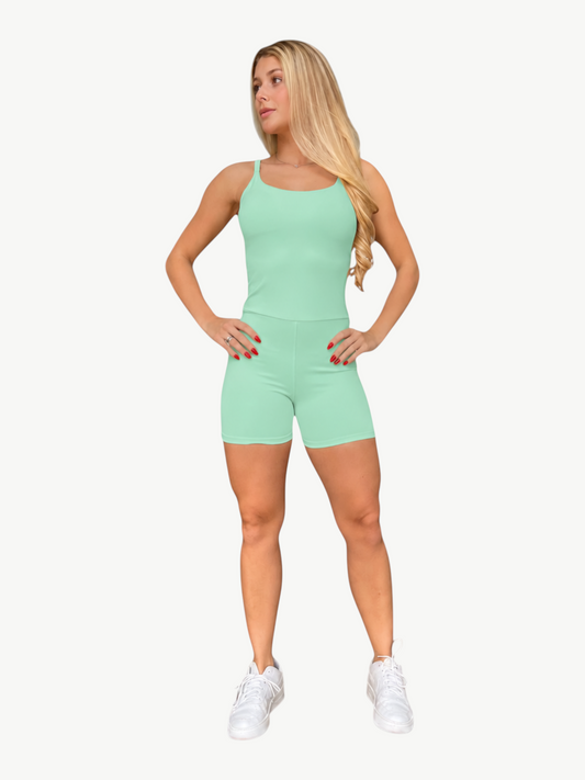 Woman wearing a mint green JM Brazilian Activewear Sculpt Romper with a fitted silhouette and spaghetti straps.