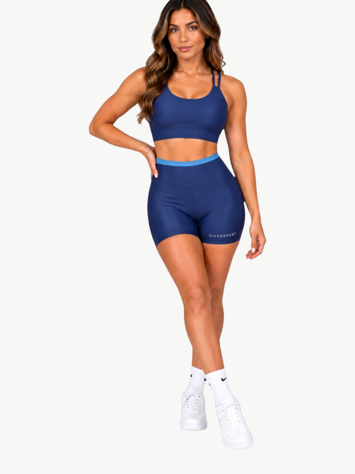 Model wearing JM Brazilian Activewear navy blue two-piece crop top and high-waisted shorts set for workouts