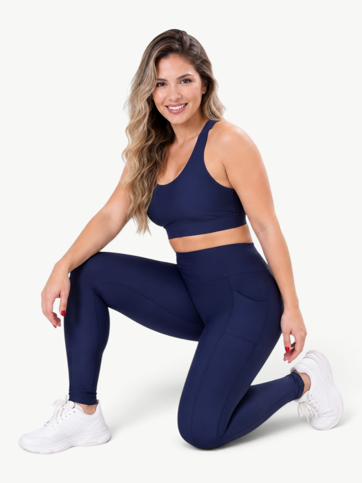 JM Brazilian Activewear navy blue high-waisted pocket leggings worn by a smiling woman in a matching sports bra