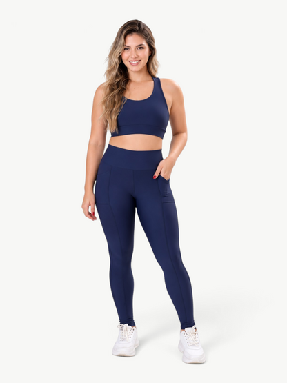 Model wearing JM Brazilian Activewear navy blue high-waisted pocket leggings and matching sports bra