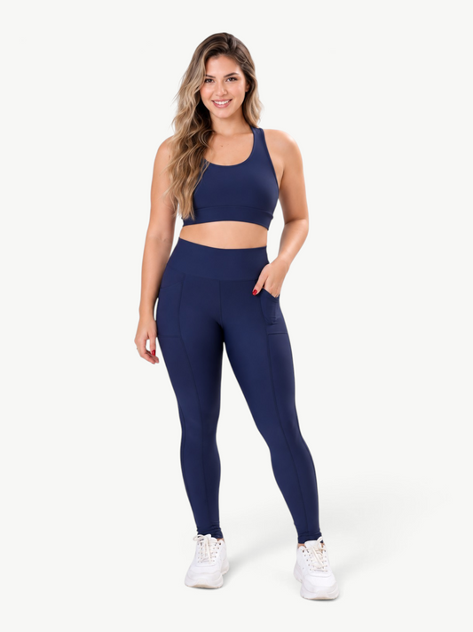 Model wearing JM Brazilian Activewear navy blue high-waisted pocket leggings and matching sports bra