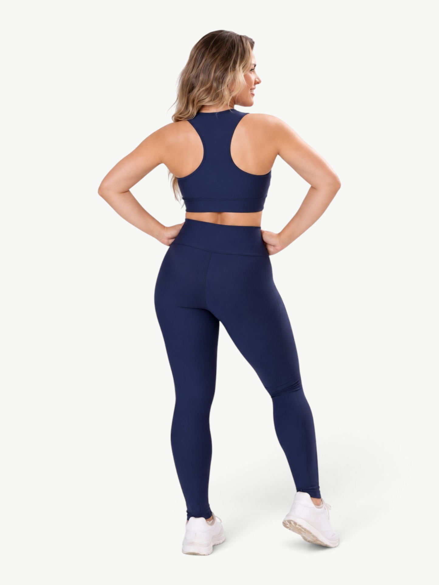 JM Brazilian Activewear navy blue high-waisted pocket leggings and matching sports bra worn by a woman from behind