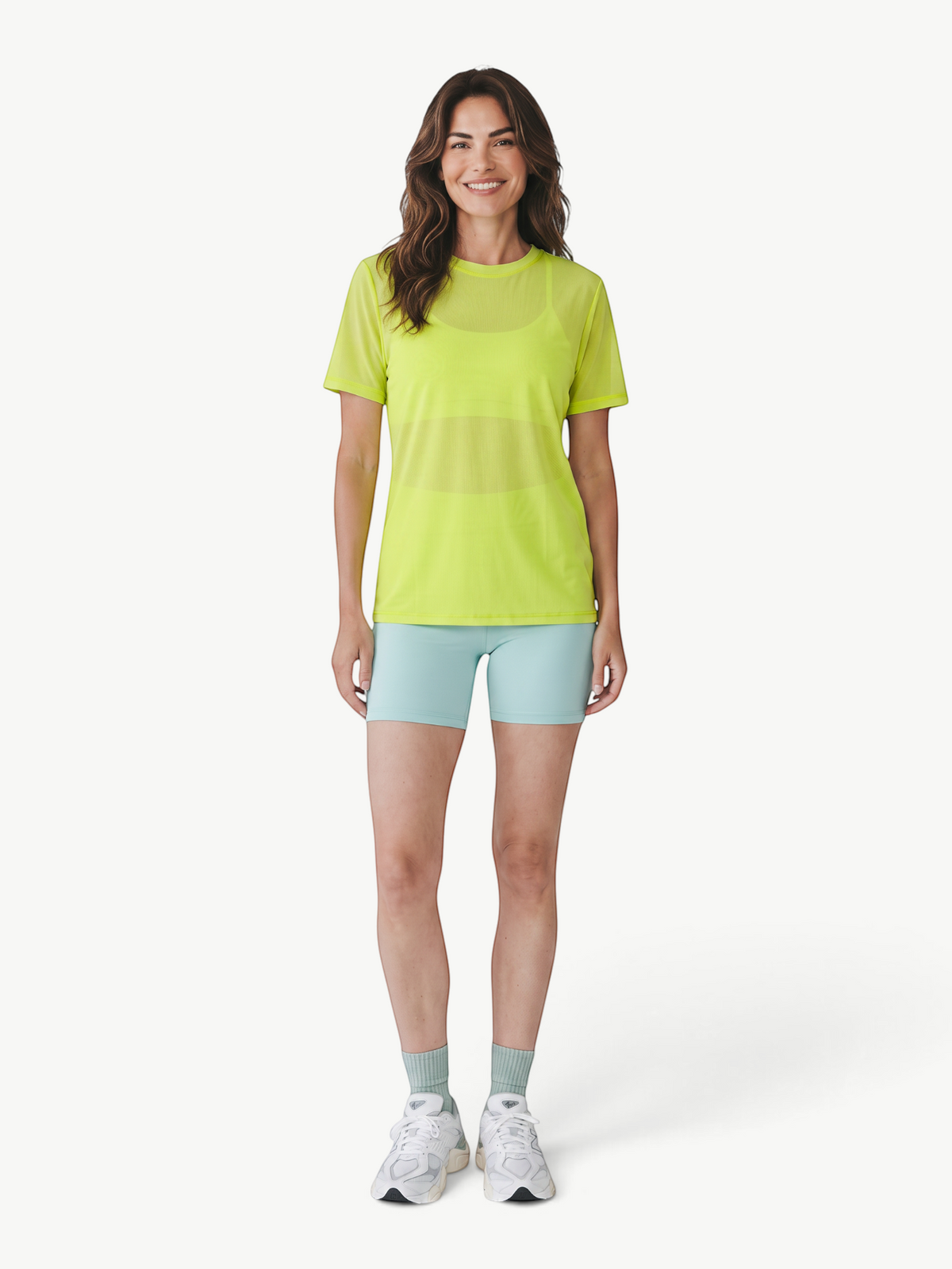 Model wearing a neon yellow JM Brazilian Activewear mesh t-shirt with light blue shorts and white sneakers