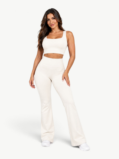 Model wearing JM Brazilian Activewear off-white Contour Flare Set with a cropped top and high-waisted flare leggings.