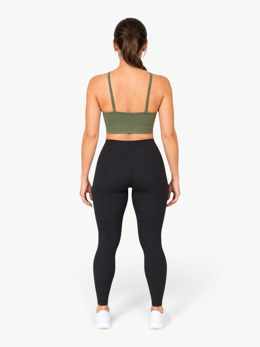 Back view of a woman wearing a JM Brazilian Activewear olive green cropped sports top with slim straps.