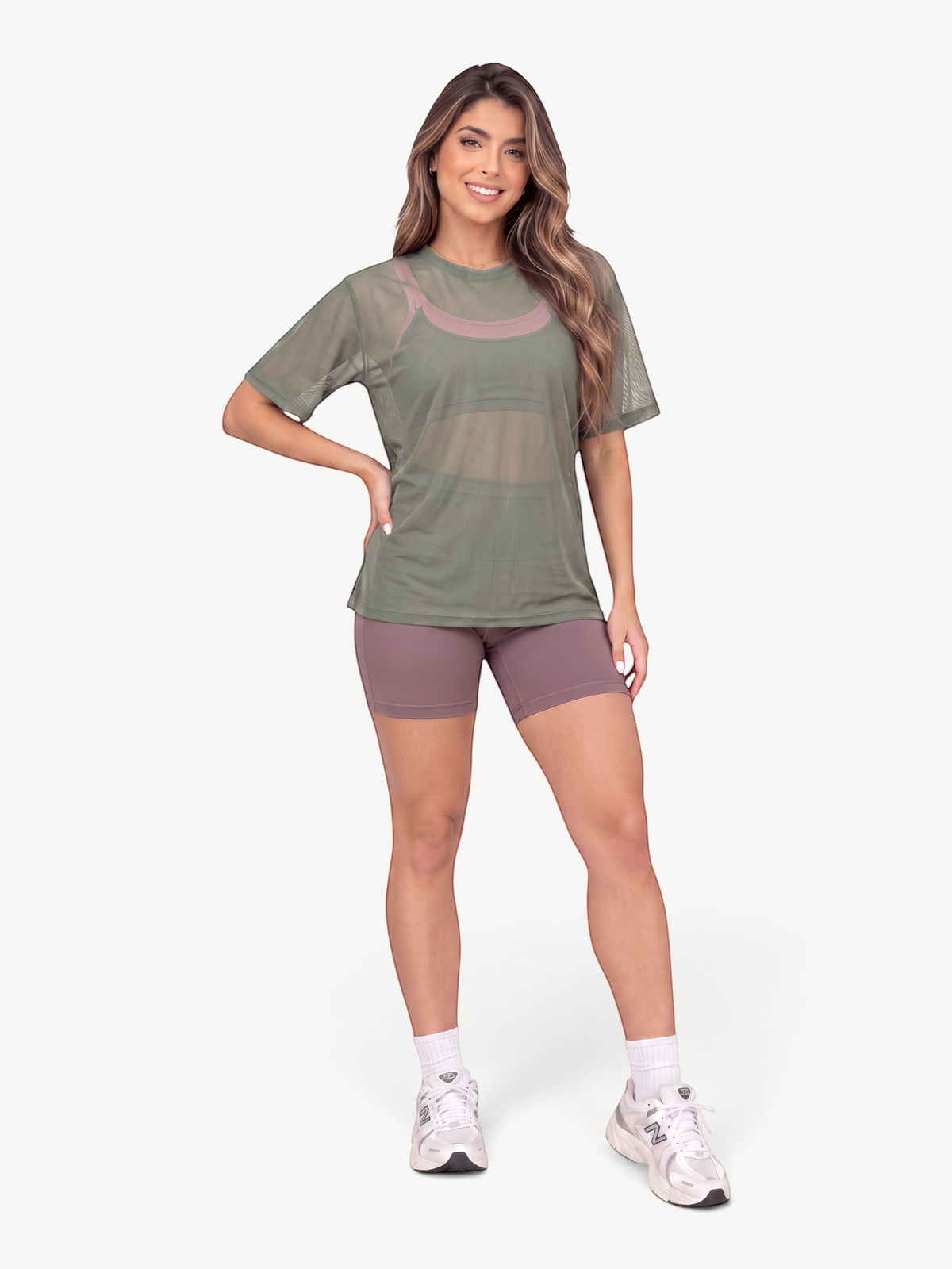 Model wearing a JM Brazilian Activewear olive green sheer mesh t-shirt over a mauve sports bra and matching shorts.