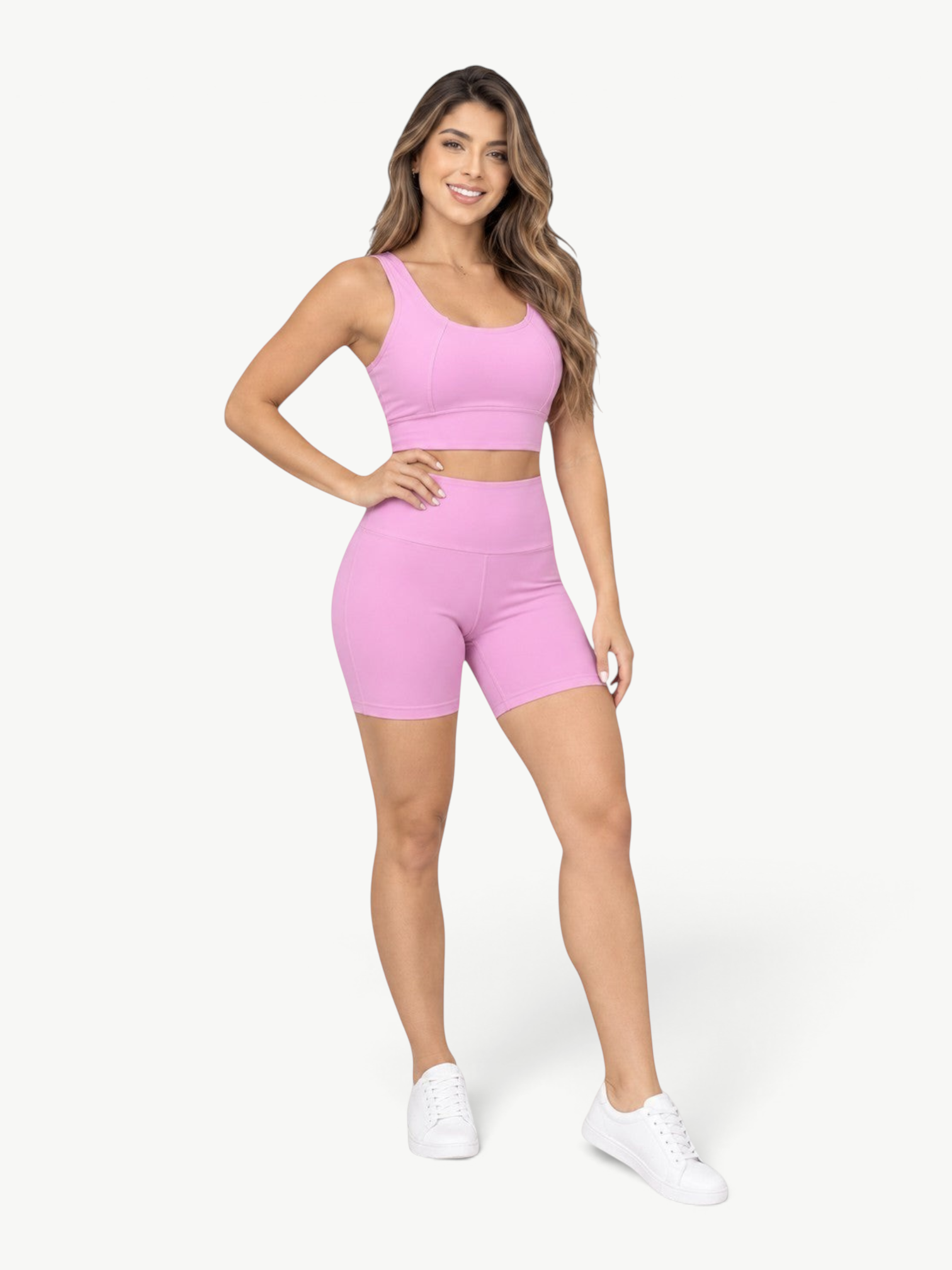 Model wearing JM Brazilian Activewear pink Sculpt Biker Short Set with a cropped tank and high-waisted shorts.