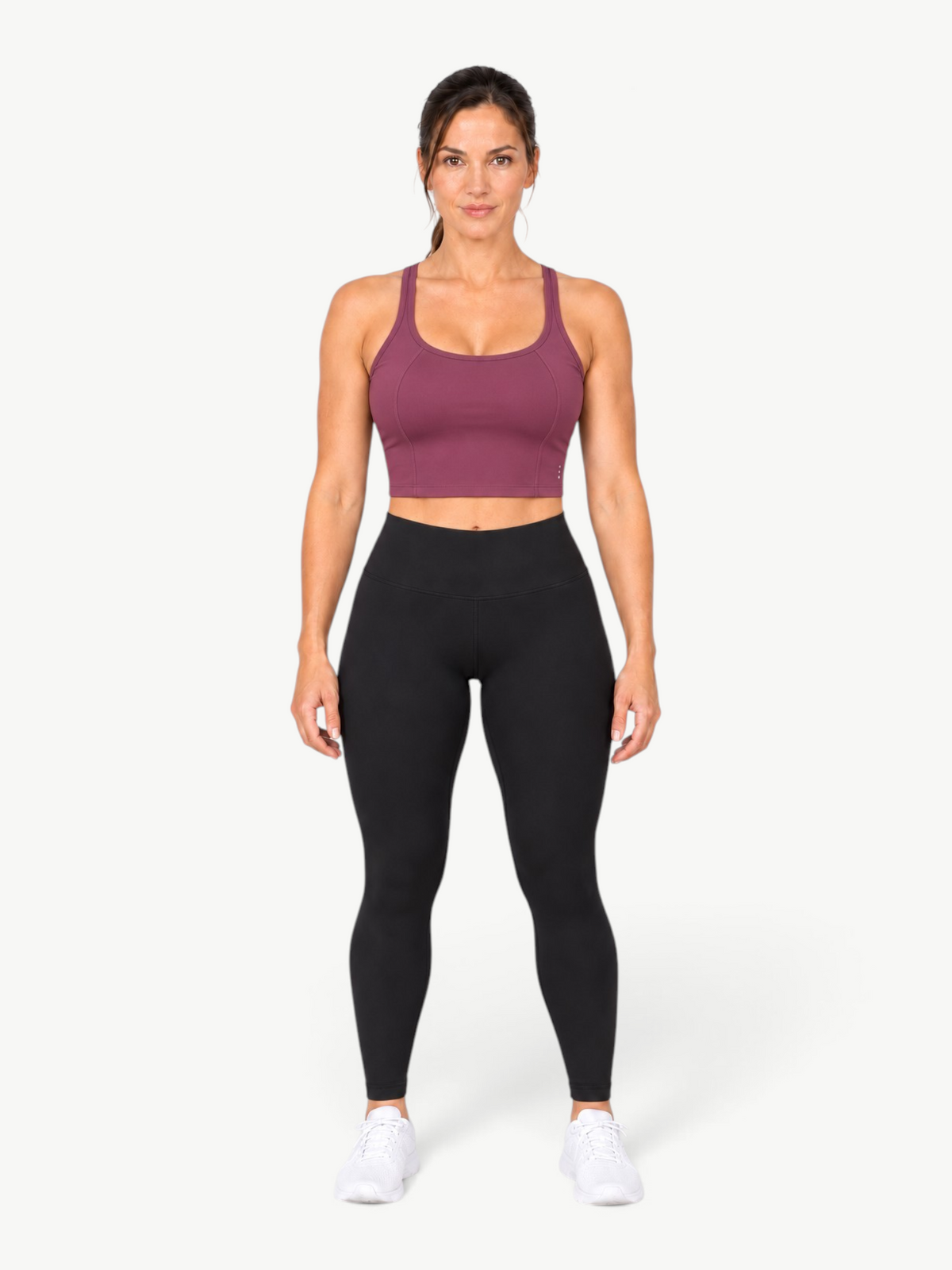 Model wearing a JM Brazilian Activewear Dallas crop top in plum with a scoop neck, paired with black leggings.