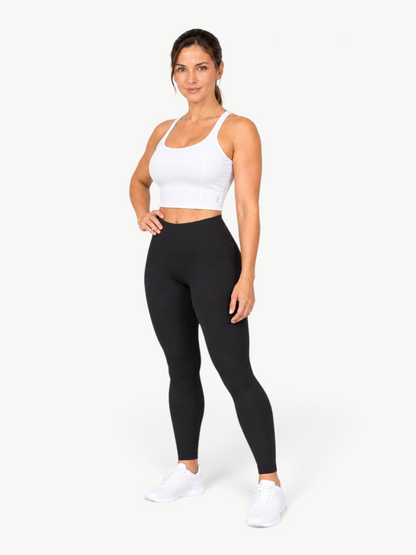 Model wearing JM Brazilian Activewear white Dallas Crop Top with black leggings and white sneakers