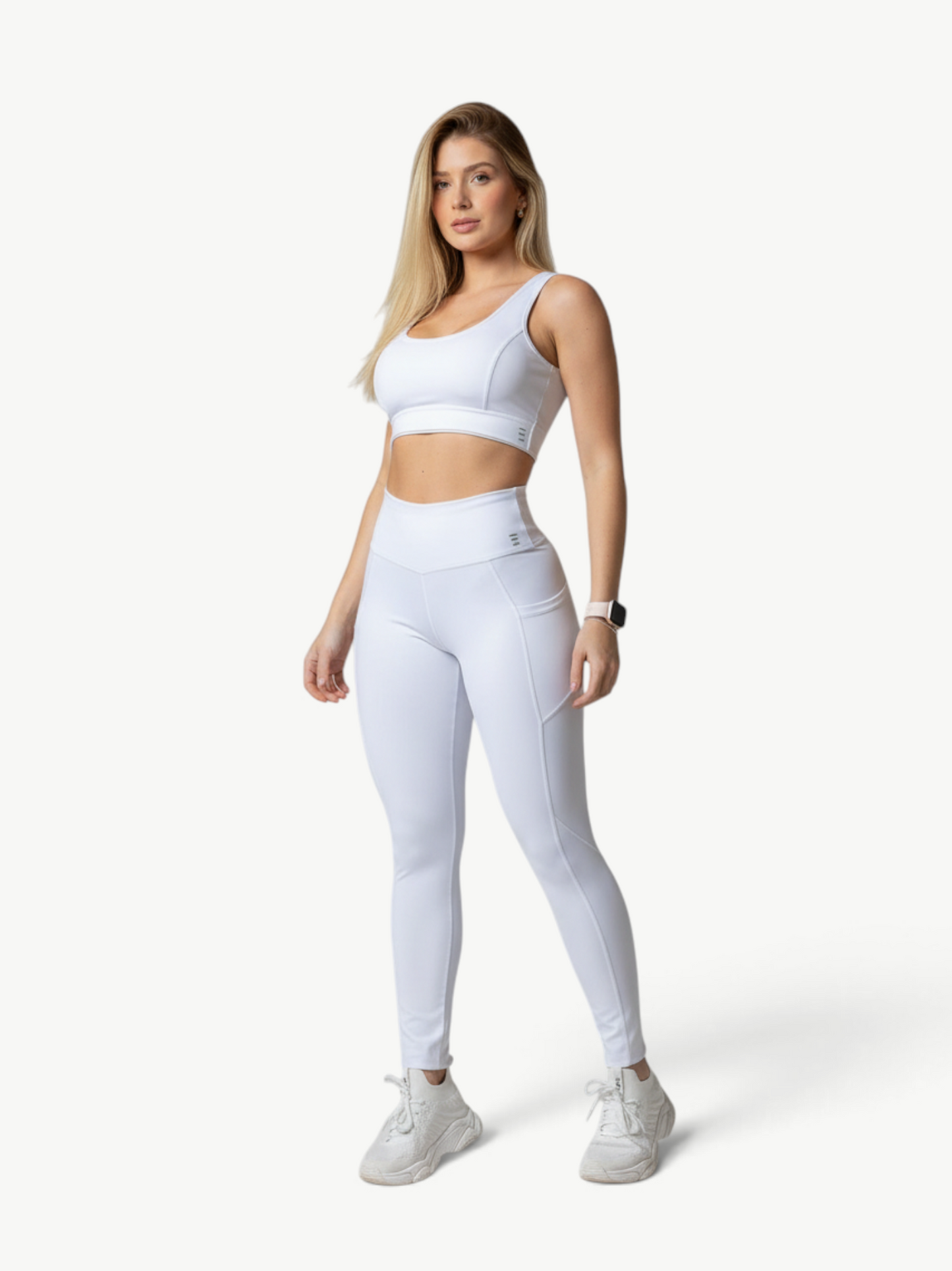 Model wearing a white JM Brazilian Activewear Polianna Legging Set with a crop top and high-waisted leggings.