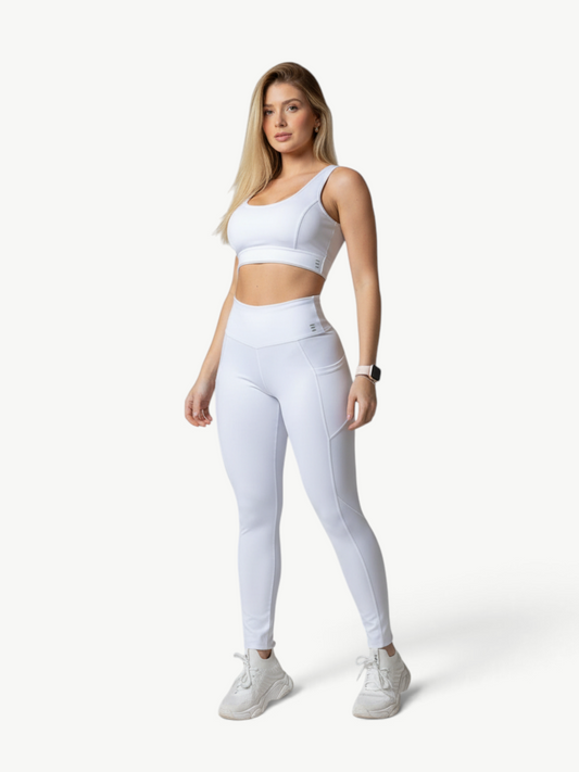 Model wearing a white JM Brazilian Activewear Polianna Legging Set with a crop top and high-waisted leggings.