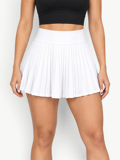 JM Brazilian Activewear white high-waisted pleated athletic skort worn with a black sports bra