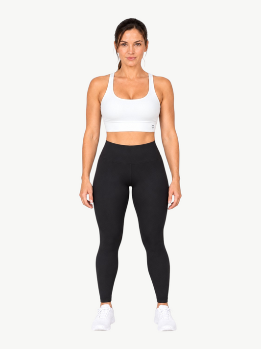 Model wearing JM Brazilian Activewear white Poliana scoop back sports bra with wide straps and supportive under-bust band
