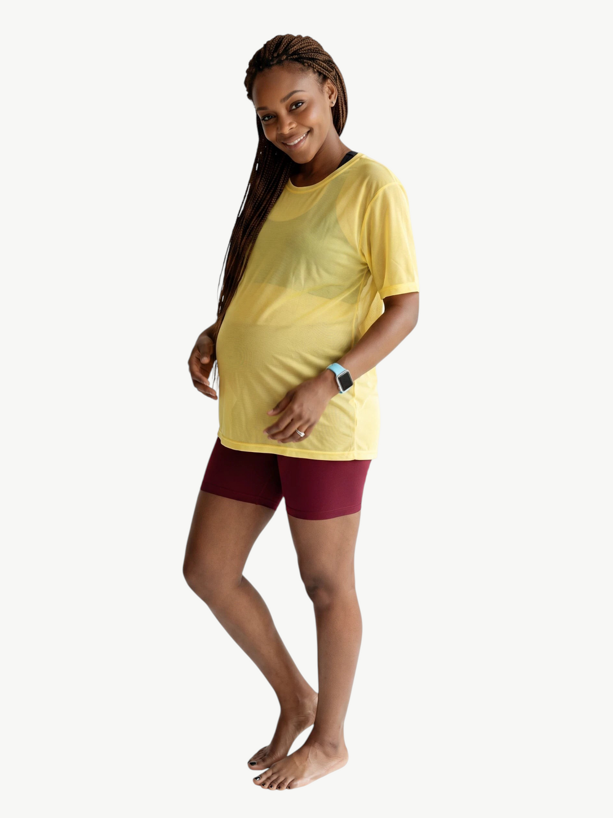 JM Brazilian Activewear yellow sheer mesh t-shirt worn by a pregnant woman with maroon shorts